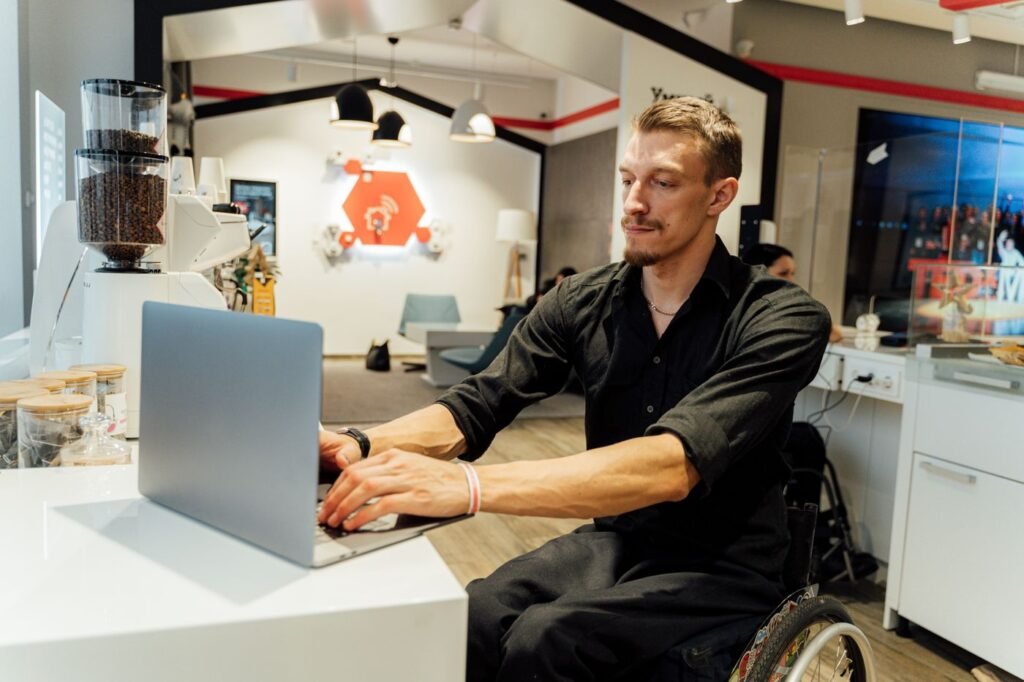 Homem em cadeira de rodas usando um notebook